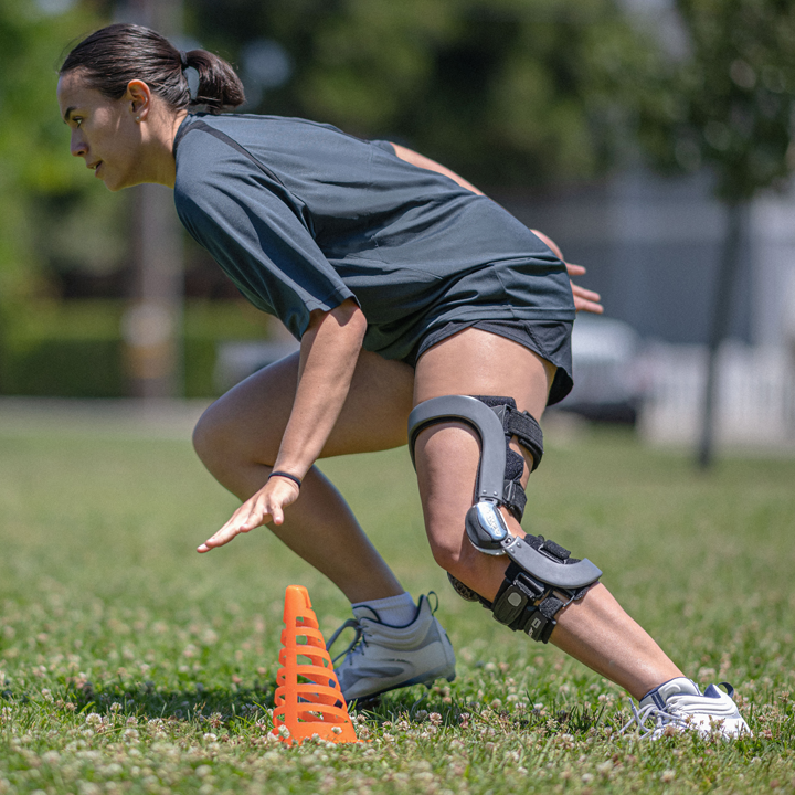 Athlete wearing a knee brace during sports training